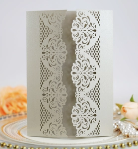 Detailed laser-cut European damask pattern on pearlized champagne wedding invitation cover