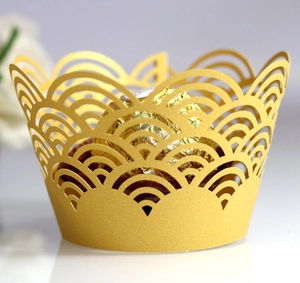 Macro shot of gold laser-cut cupcake wrapper featuring elegant wave patterns