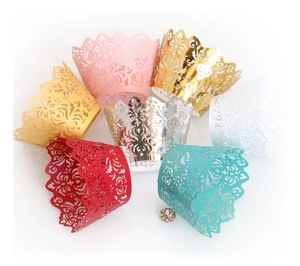 Intricate laser-cut cupcake wrappers in multiple metallic colors with vine patterns
