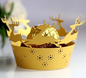 Laser-cut gold cupcake wrapper featuring Christmas reindeer and snowflake hollow patterns