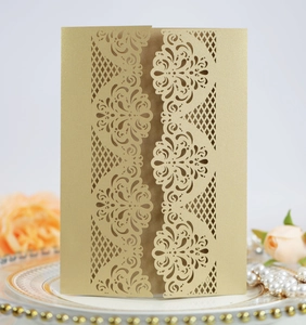 Detailed laser-cut champagne gold wedding invitation cover with elegant lace patterns