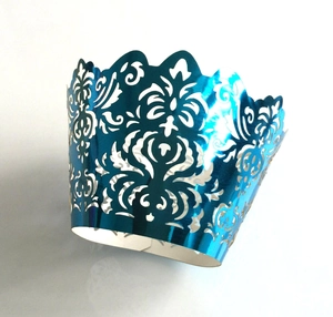 Laser cut electric blue cupcake wrappers with ornate hollow vine patterns for weddings