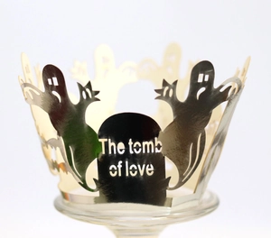 Detail of laser-cut Halloween cupcake wrapper with ghost and tomb of love engraving