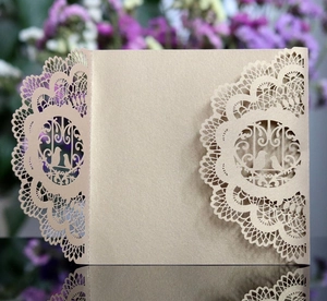 Macro view of champagne gold laser-cut lace wedding invitation with bird motif details