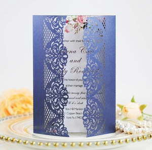 Close-up of laser-cut lace pattern on dark blue pearlescent paper wedding invitation card
