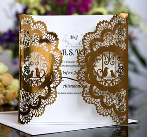 Laser-cut wedding invitation with gold foil mandala and lovebirds over white card