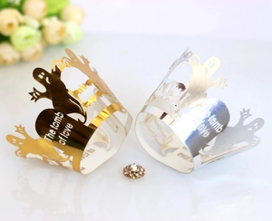 Laser-cut Halloween cupcake wrappers in gold and silver with ghost and bat patterns