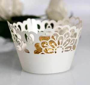 Detailed laser cut lace cake wrapper in pearl white with intricate floral hollow design