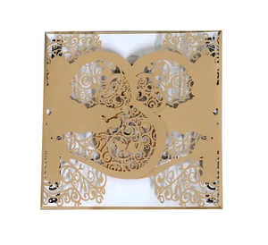 Detail of laser-cut floral wedding invitation cover in metallic champagne gold finish
