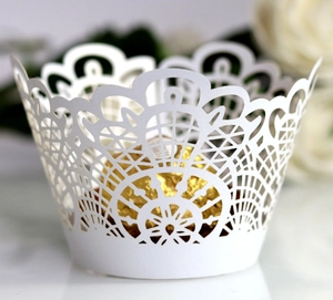Detailed laser-cut white lace cupcake wrapper featuring an elegant geometric mesh design