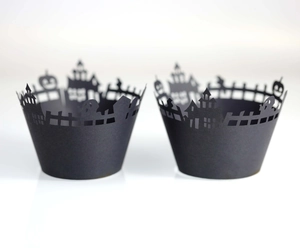 Halloween cupcake wrappers with laser-cut castle and pumpkin patterns in matte black paper