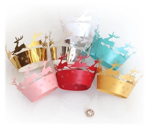 Laser-cut reindeer cupcake liners with festive snowflake patterns in vibrant colors