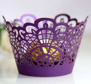 Deep purple laser-cut cupcake wrappers with elegant lace design for party decor