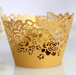 Detailed laser-cut rose pattern on metallic gold cupcake wrapper with matte finish