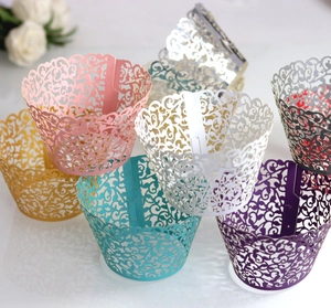 Detailed laser-cut vine patterns on multicolored paper cupcake liners for party decor