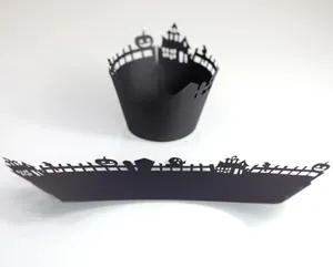 Detail of laser-cut Halloween cupcake wrappers with pumpkin and castle silhouette design