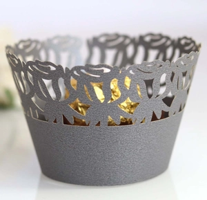 Macro detail of laser-cut rose floral cupcake wrapper with metallic silver finish