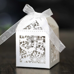 Detailed laser-cut bird and heart patterns on white pearlescent paper candy gift box