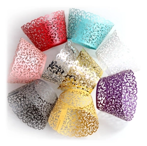 Macro shot of assorted laser-cut vine lace cupcake wrappers in vibrant pearlescent colors