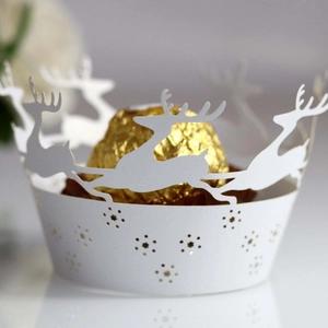 Laser-cut reindeer cupcake wrapper in white paper for festive Christmas cake decoration