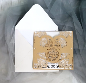 Detailed macro view of champagne gold laser-cut baroque lace wedding invitation card