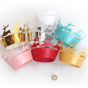 Laser-cut Christmas cupcake wrappers with reindeer and snowflake designs in multi-color