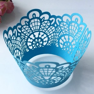 Intricate laser-cut sky blue lace cupcake wrapper detail with floral hollow patterns