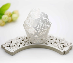 Laser-cut white butterfly muffin cupcake liners with intricate wing patterns for wedding