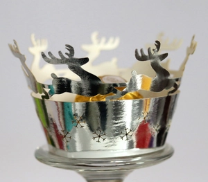 Silver laser-cut Christmas cupcake wrappers with reindeer and snowflake patterns