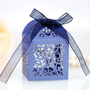 Navy blue laser cut candy box with elegant floral pattern and silk ribbon bow for wedding