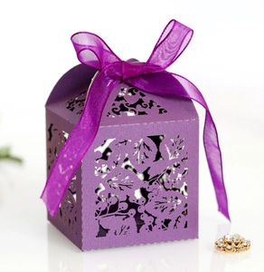 Détail boîte cadeau violette découpée au laser avec motifs de feuilles et ruban organza
