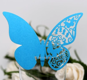 Dettaglio segnaposto a farfalla blu tagliato al laser per decorazione di calici
