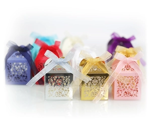 Elegant laser cut floral wedding favor boxes with silk bows in multiple colors