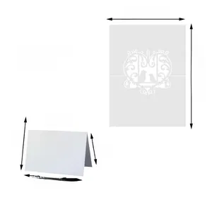 Detail of laser-cut white butterfly table cards with heart patterns and bird motifs