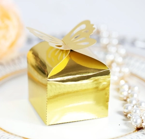 Close-up of golden hollow butterfly gift box on elegant porcelain plate with roses