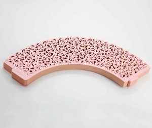 Detail of pink laser-cut cupcake wrappers with elegant lace vine pattern for wedding decor