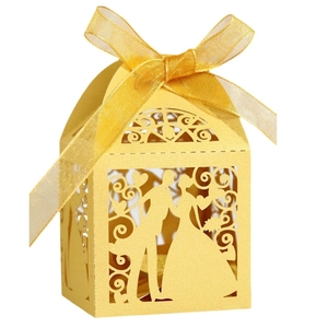 Laser-cut wedding candy box in yellow pearl paper with ribbon and couple silhouette