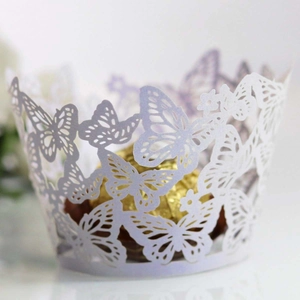 Detailed laser-cut purple cupcake wrapper with butterfly pattern and golden chocolate