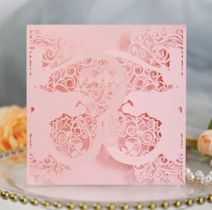 Detailed laser cut patterns on pink wedding invitation with romantic floral hollow design