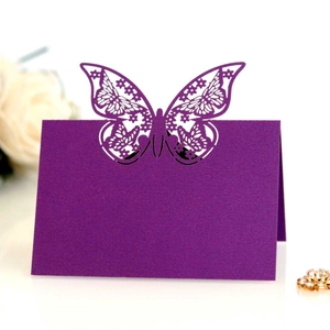 Elegant laser-cut butterfly place card in deep purple for wedding table decorations