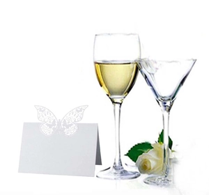 Detail of white laser-cut butterfly place card for wedding tables and banquet decor
