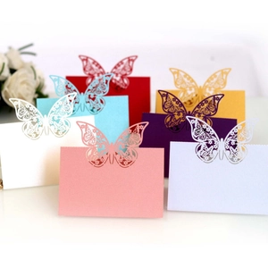 Assorted laser-cut hollow butterfly place cards for wedding tables in multiple colors