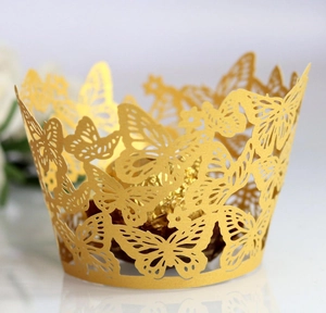 Detail of laser-cut butterfly cupcake wrapper in champagne gold with 3D wings