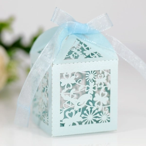 Detail of light blue laser-cut gift box featuring intricate bird and floral patterns