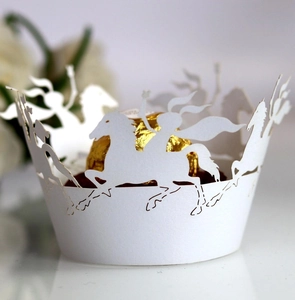 Laser-cut white paper cupcake liners featuring dynamic horse and knight silhouettes