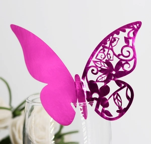 Elegant laser-cut hollow butterfly place cards in pearlescent purple for wedding glass decor