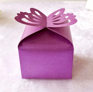 Detailed view of purple kraft paper candy box with a laser-cut 3D butterfly lid design