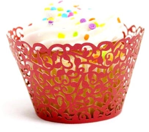 Macro shot of red laser-cut floral cupcake wrapper with intricate vine patterns