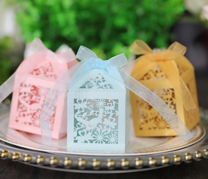 Laser cut gift boxes with bird and floral patterns featuring organza ribbons