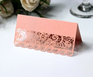 Detailed laser cut lace floral pattern on pearl pink wedding table place card